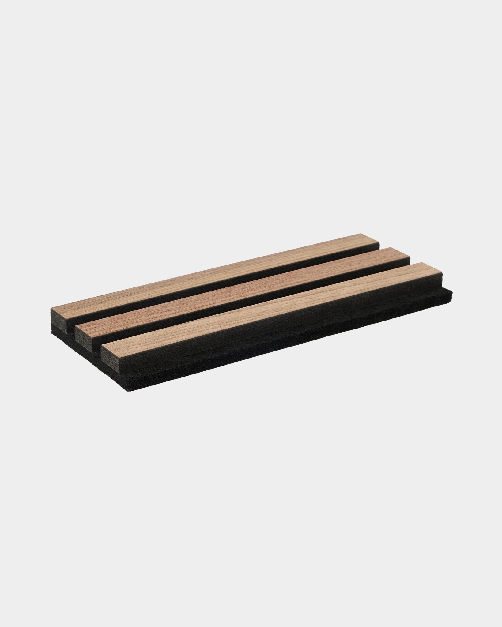 Akupanel slat sample with walnut wood finish on black acoustic backing, plain white background