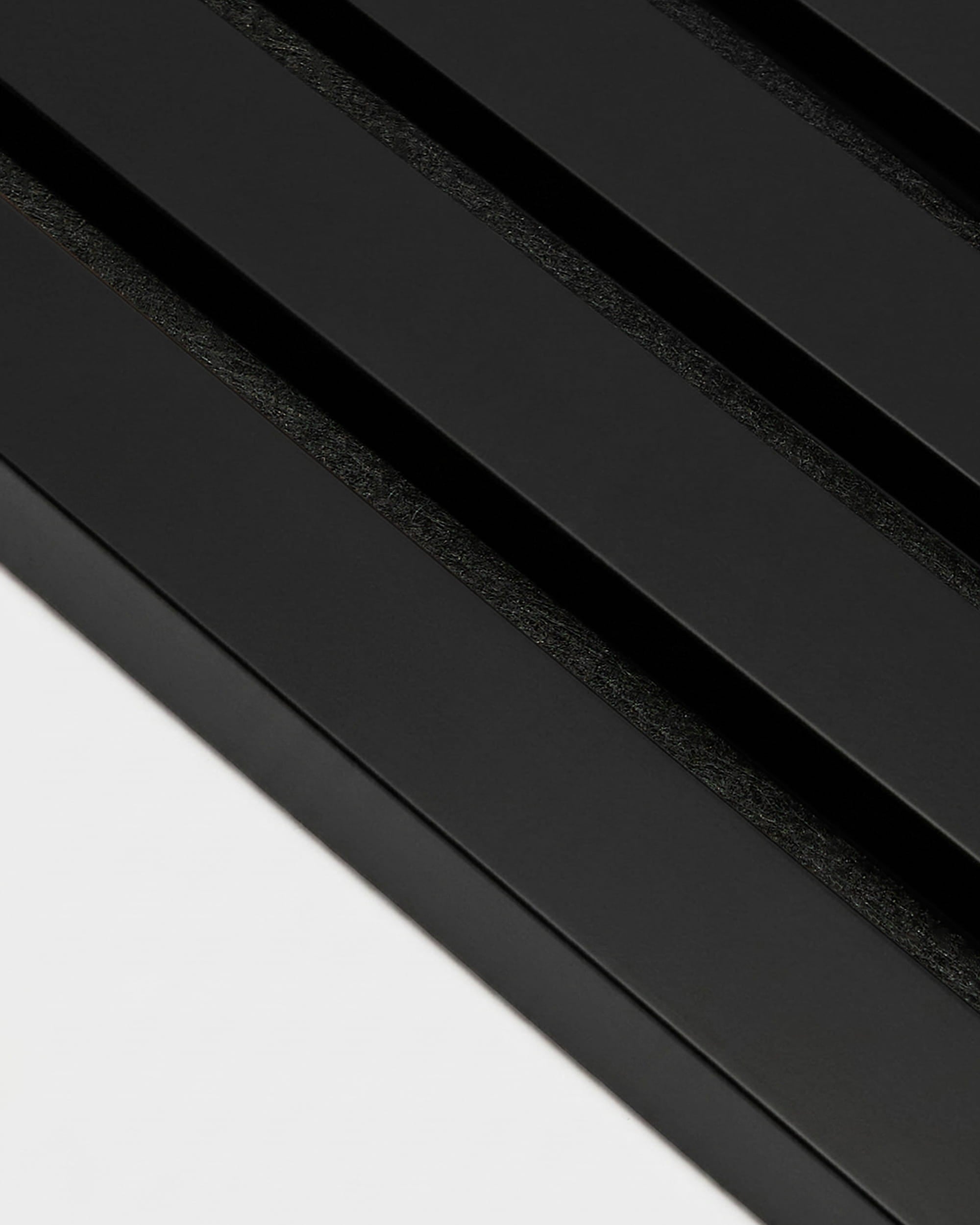WoodUpp black-wrapped end lamella (240 x 2.2 cm) designed for Akupanel acoustic panels, adds a clean, modern finish to Nordic-inspired panel installations.