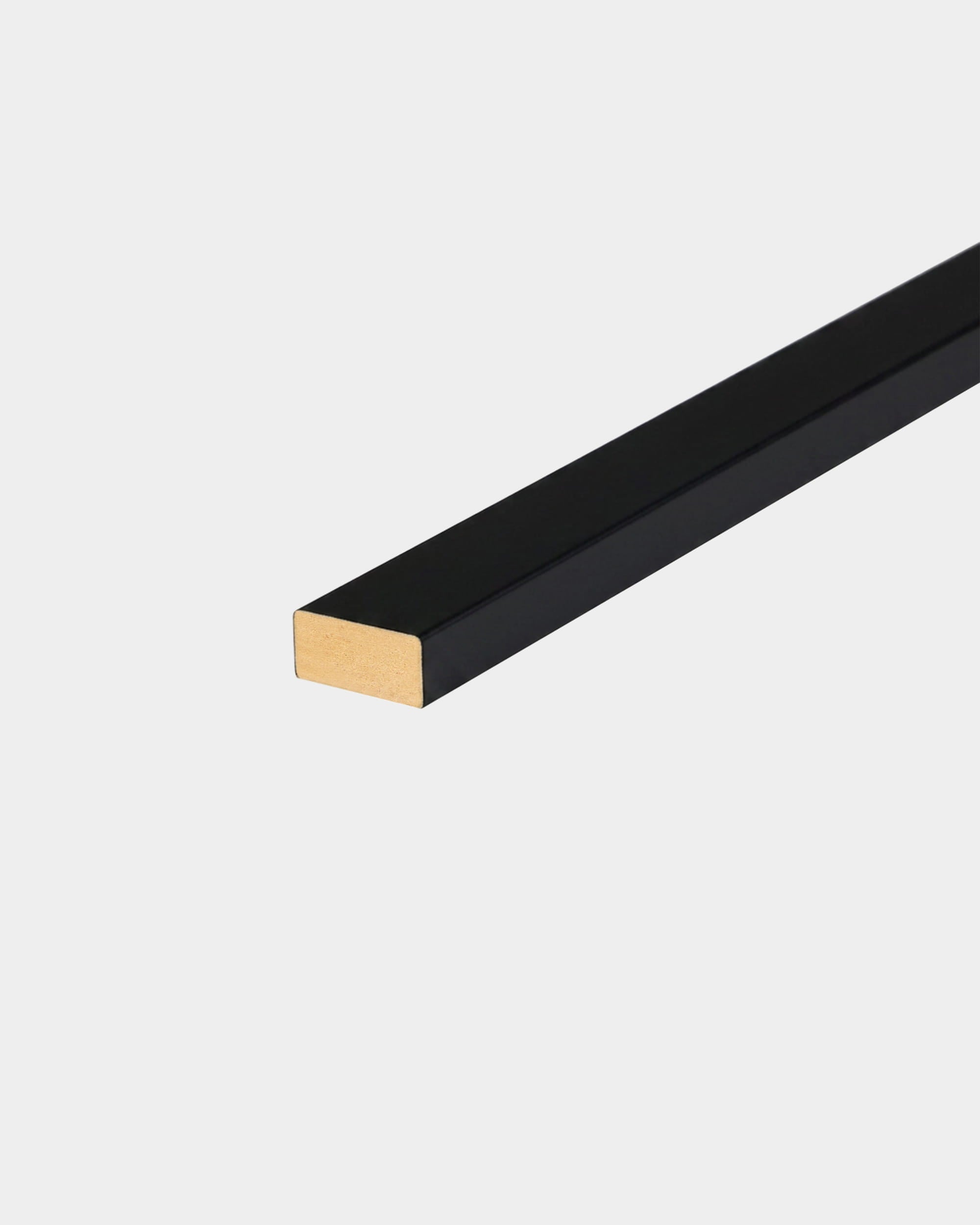 WoodUpp Lamella installation accessory, a rectangular black and gold metal bar, shown on a plain white background.