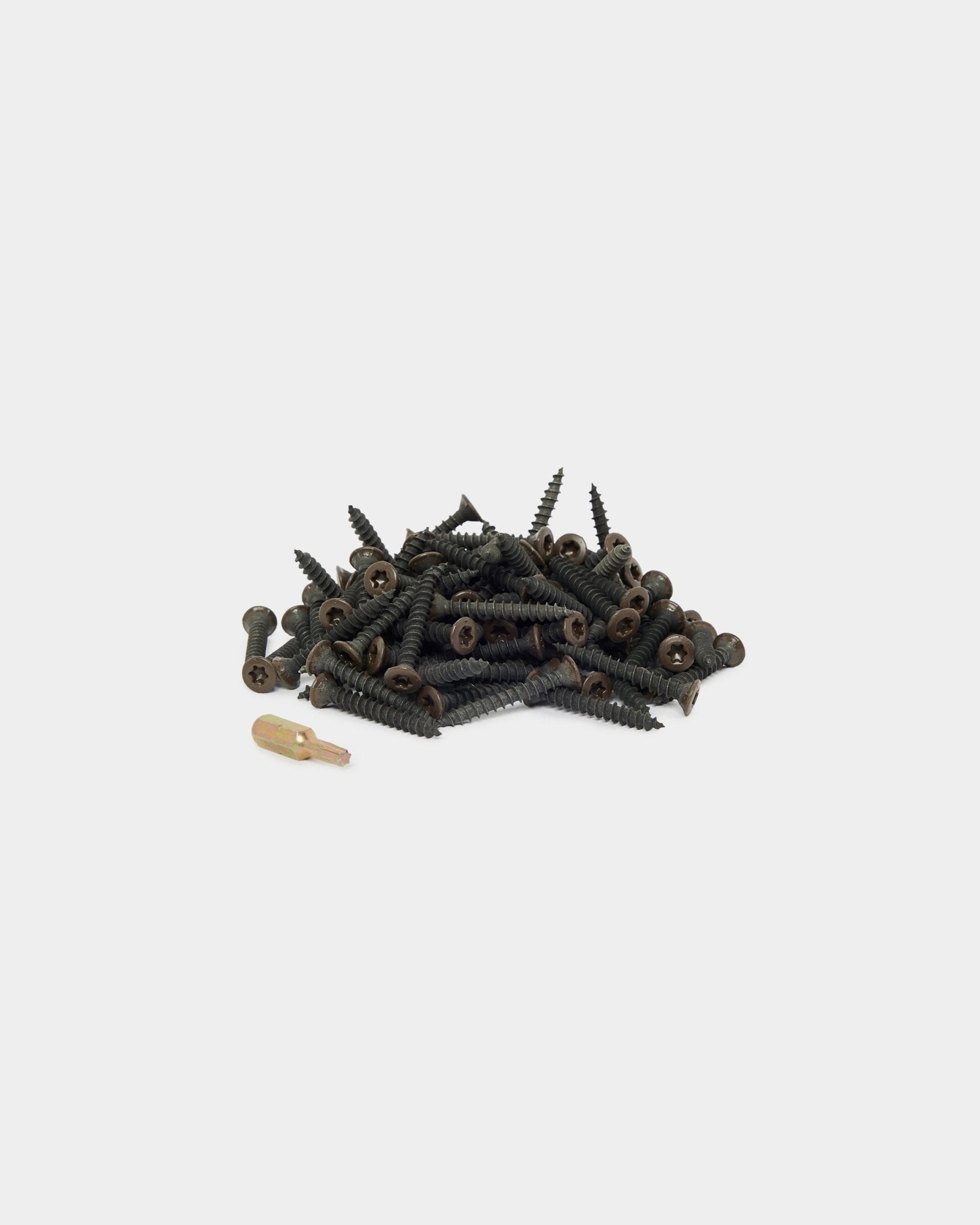 Bronzed brown installation screws and driver bit on a plain white background.