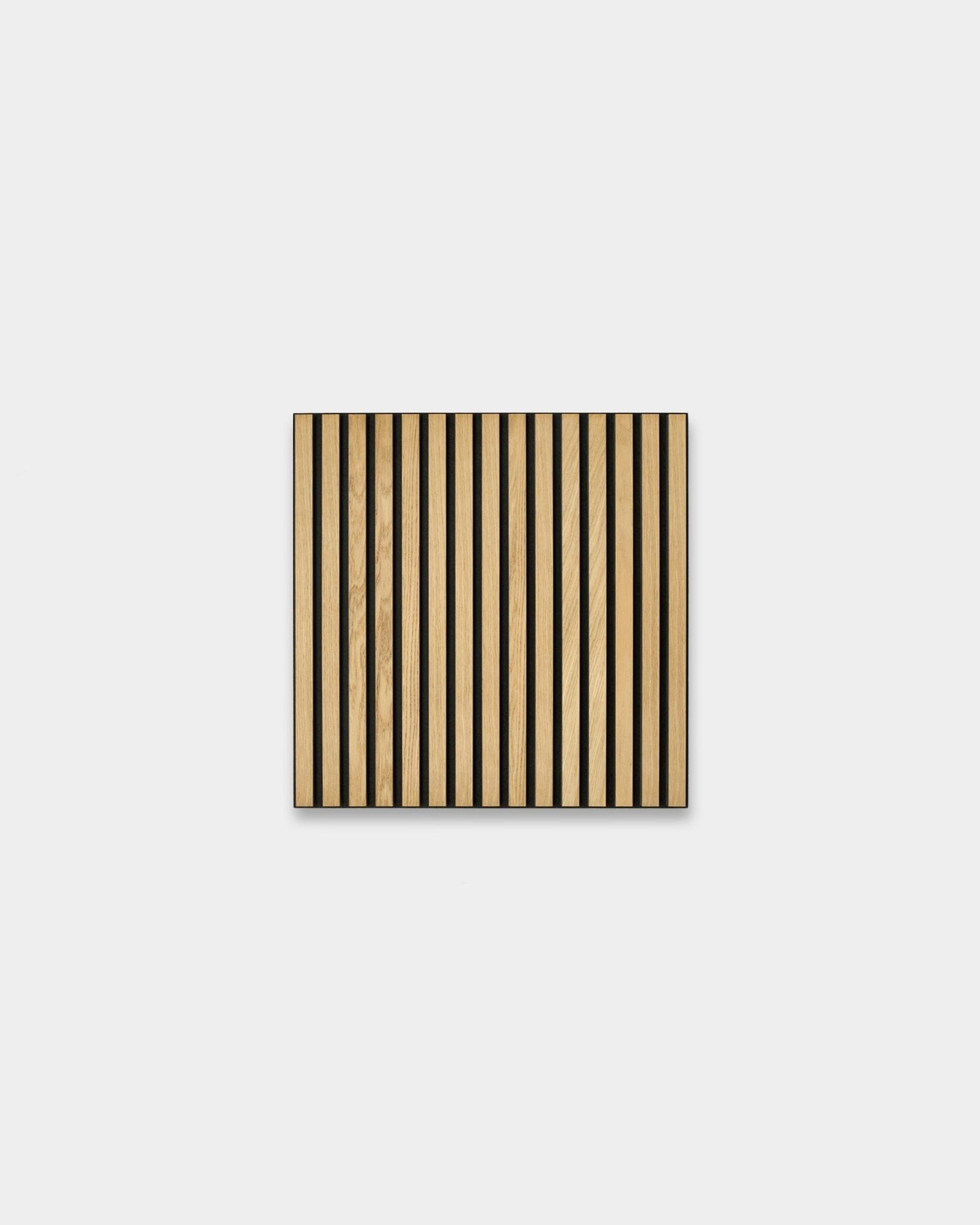 Akupanel acoustic slat panel with classic oak slats and black felt backing on plain light-grey background