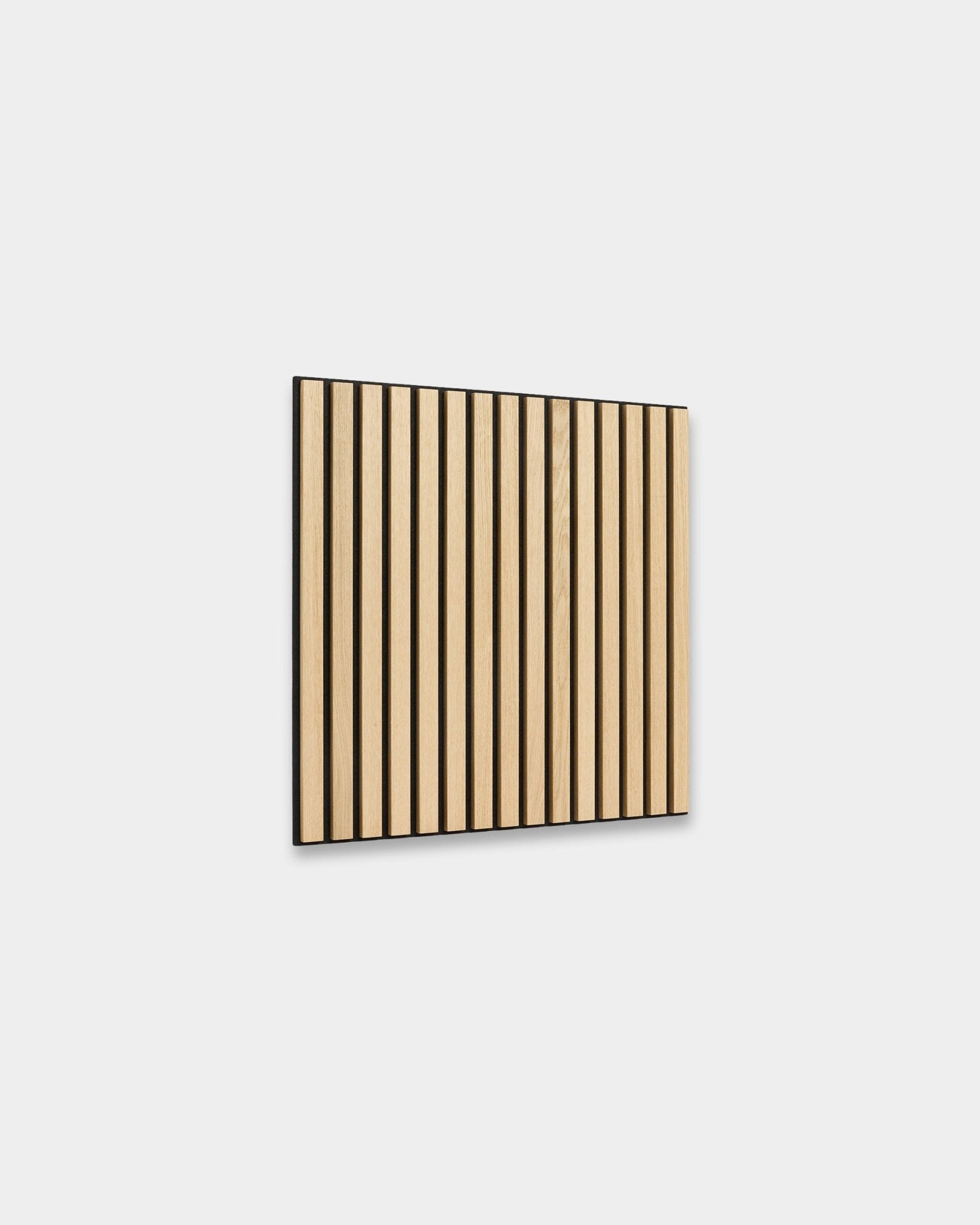 Akupanel acoustic slat panel in Classic Oak on black felt, shown on a plain light grey background