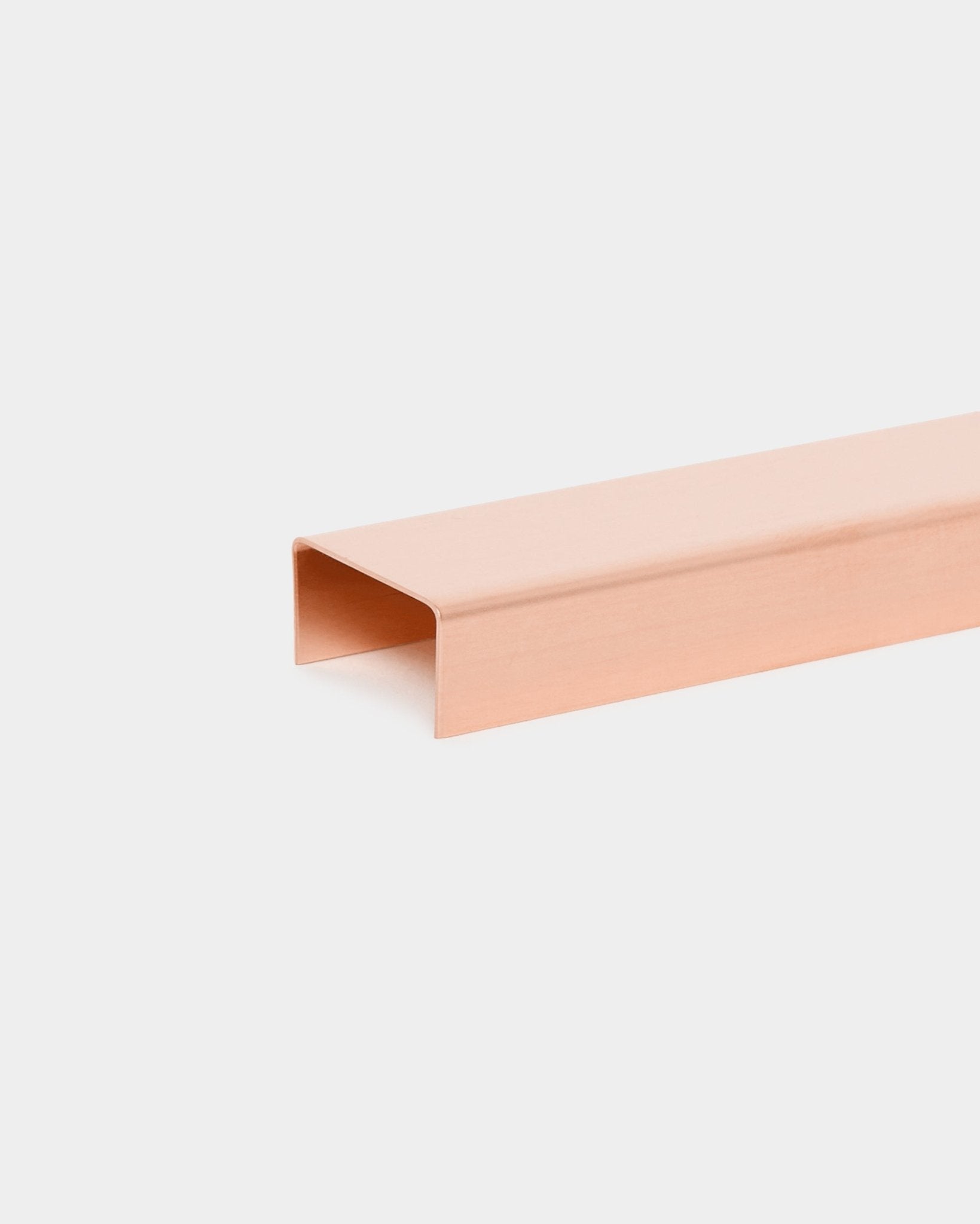 Liva metal cover profile in copper finish on a plain white background