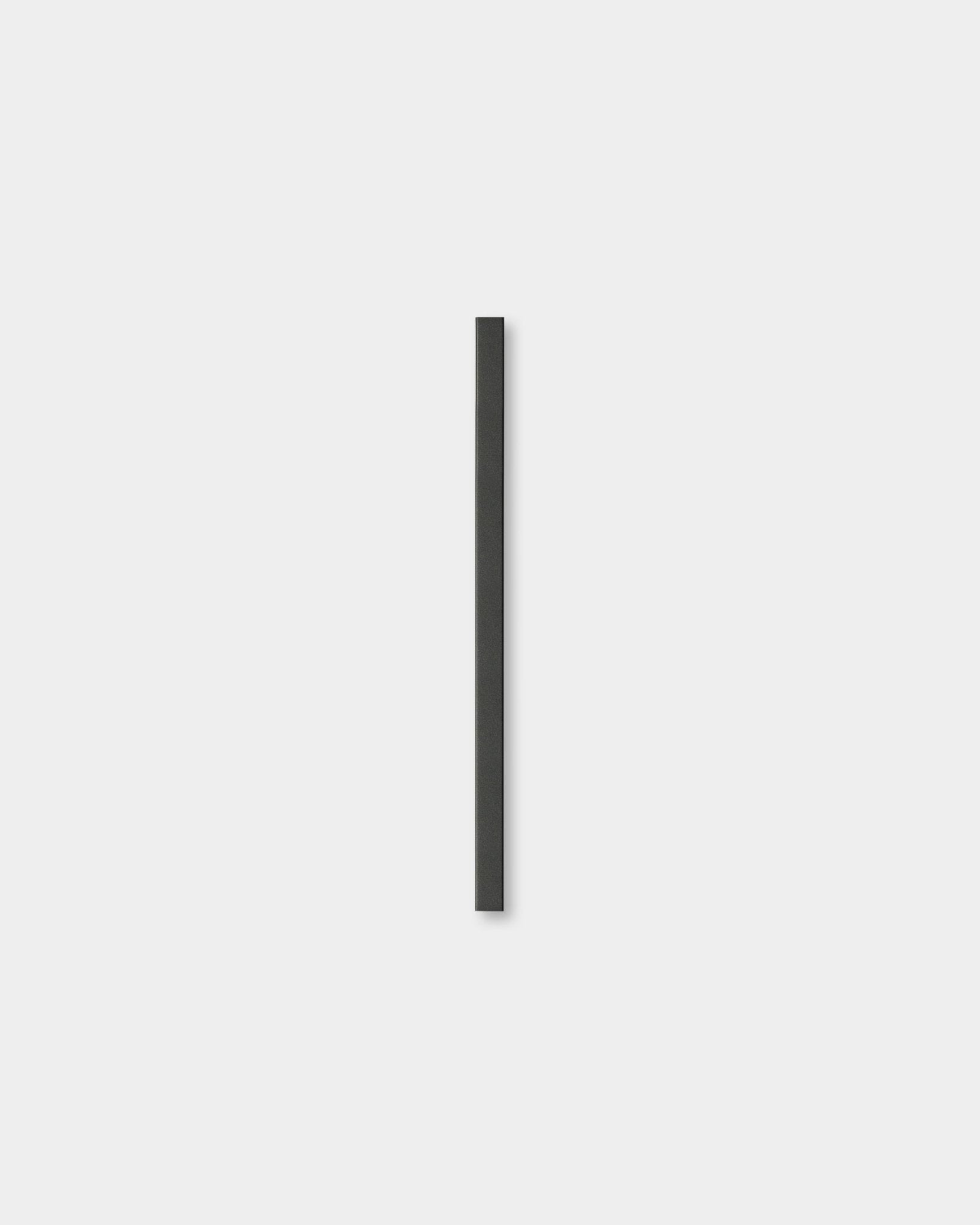 Liva cover profile in black aluminum on a plain light grey background