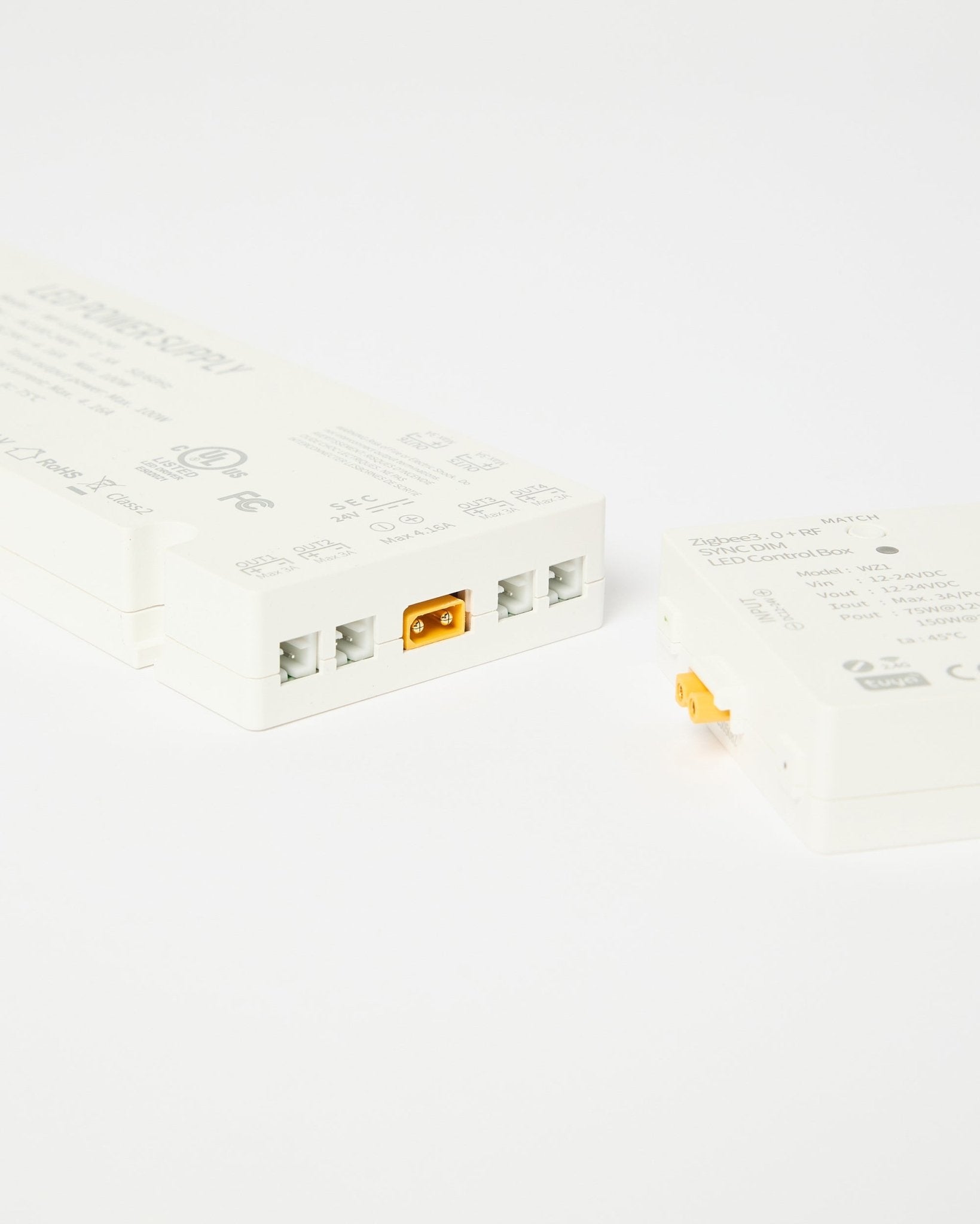 White plastic LED control boxes with connectors on a plain white background.