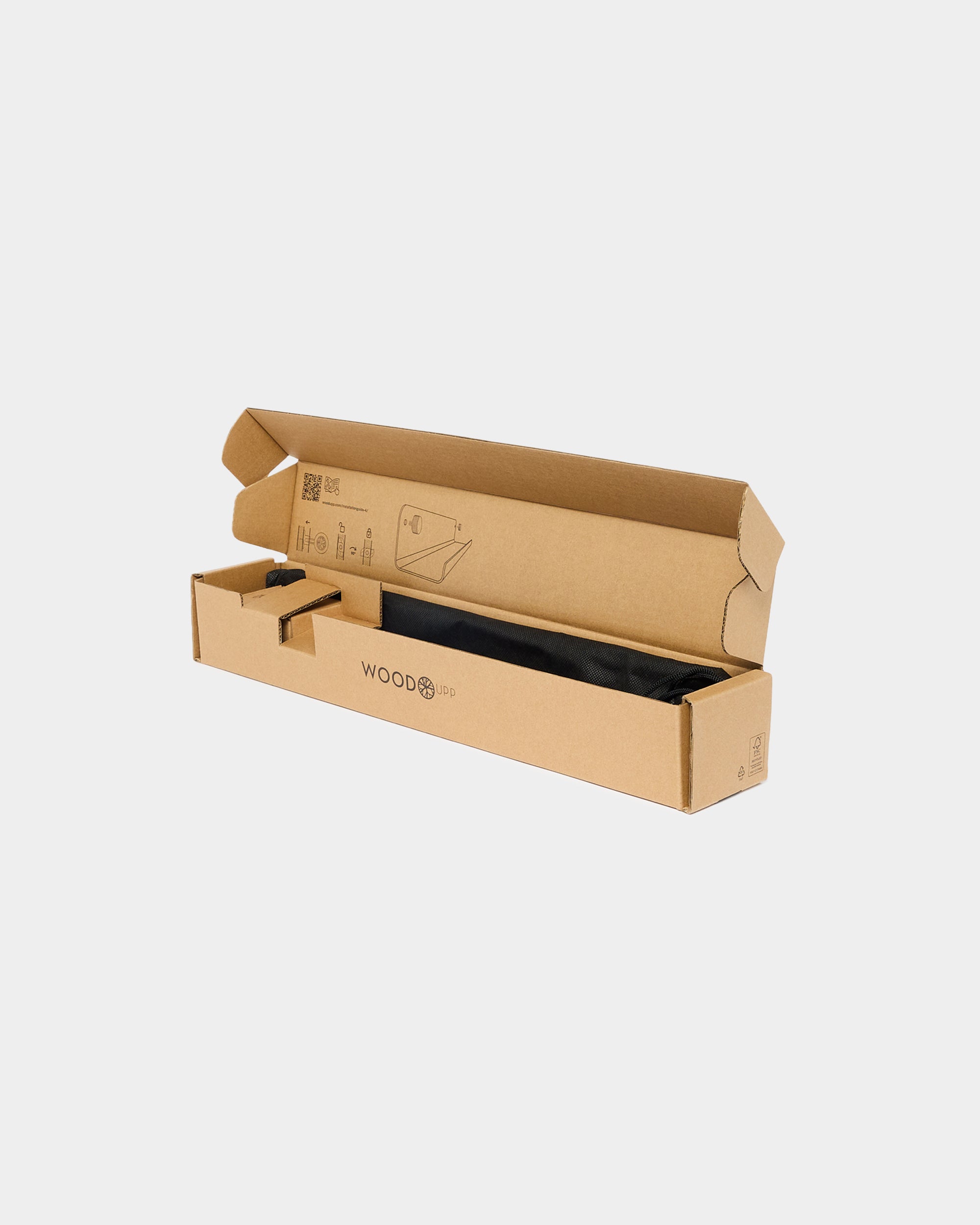 Cardboard packaging box with WOODUPP logo containing a black fabric bag on a plain white background