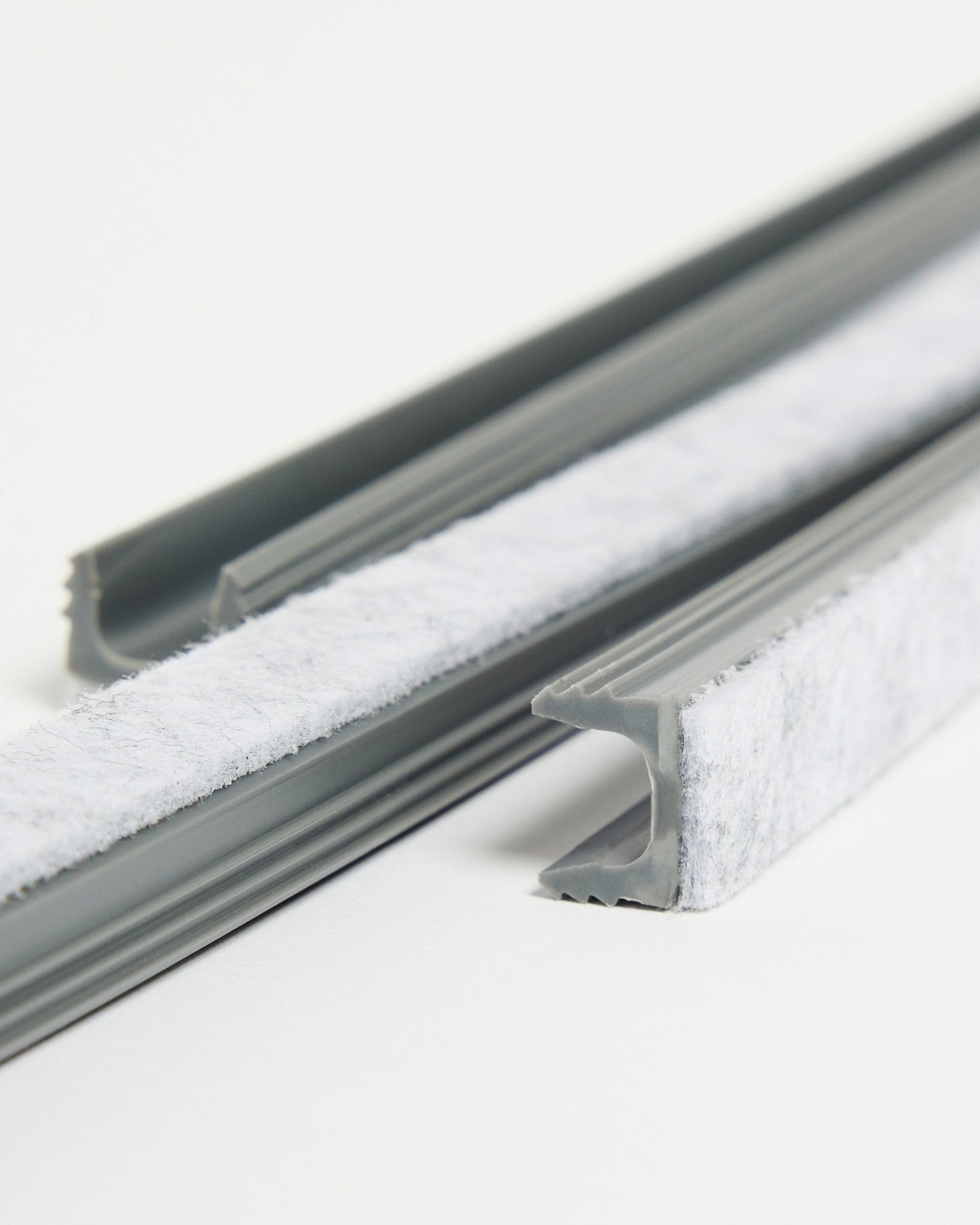 Dupps Pop-on cable covers in grey with white felt strip on a plain white background