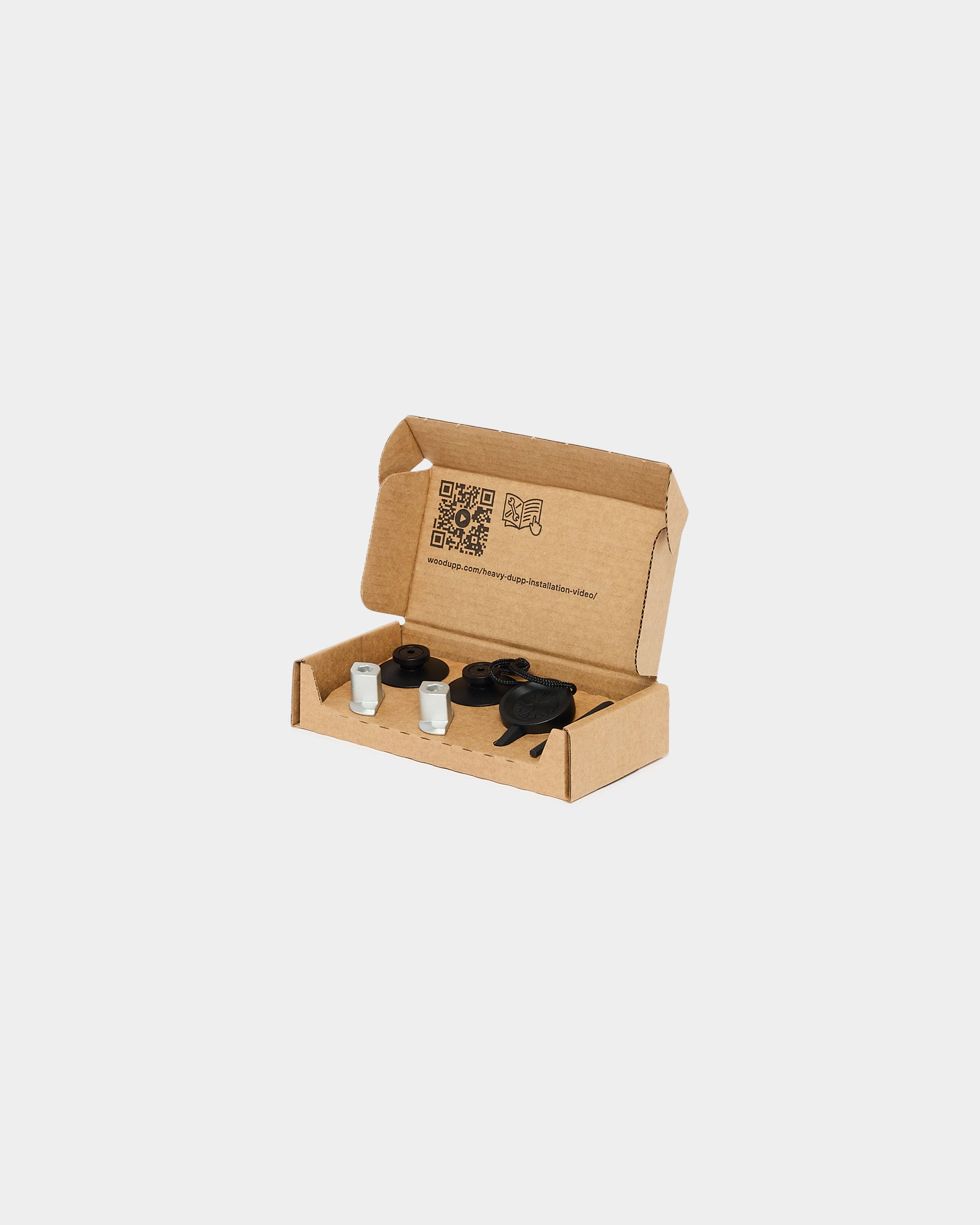 Dupps mounting hardware kit with black plastic fittings and metal anchors in a cardboard box on a white background