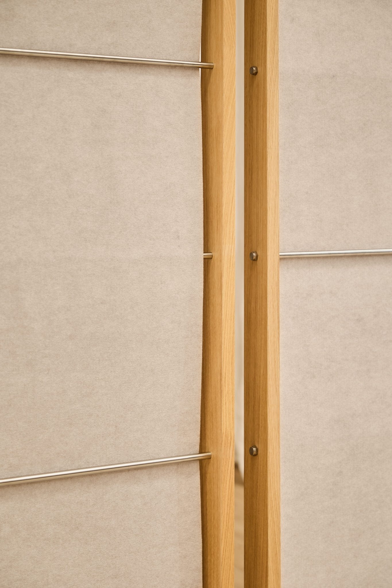 Closeup of two WoodUpp Vigg acoustic felt panels (58x241cm, light beige), separated by a slim gap, ideal for minimalist room dividers.