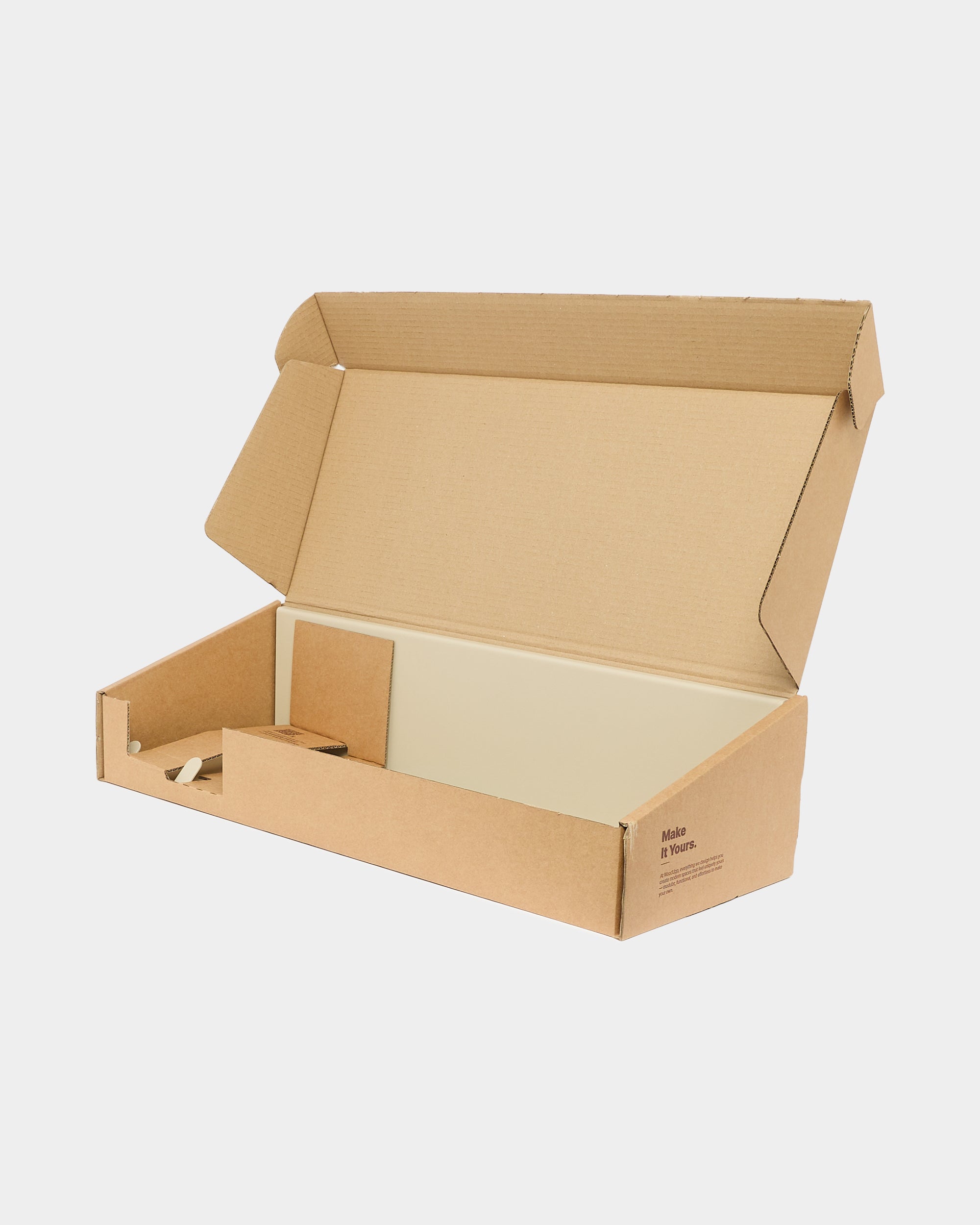 Open kraft cardboard box with unfolded flaps and empty interior, placed on a plain white background, suitable for packaging or shipping WoodUpp acoustic panels.