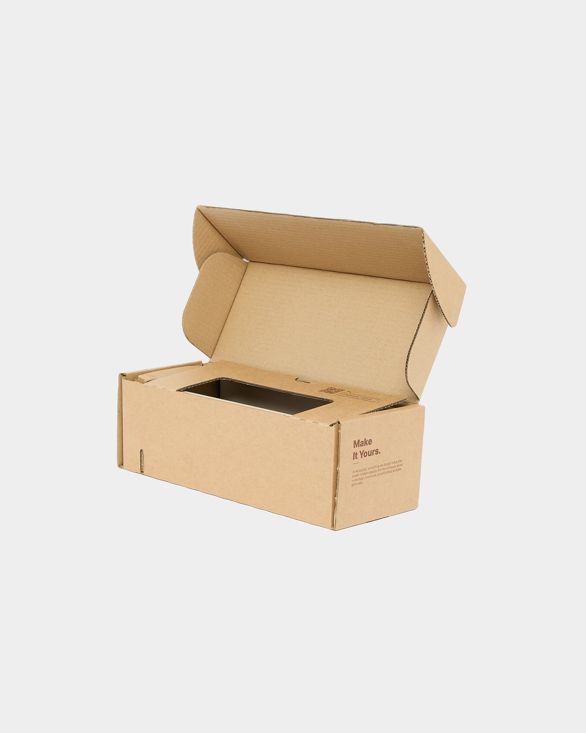 Open corrugated cardboard box with folded lid and rectangular inner cutout on plain white background.