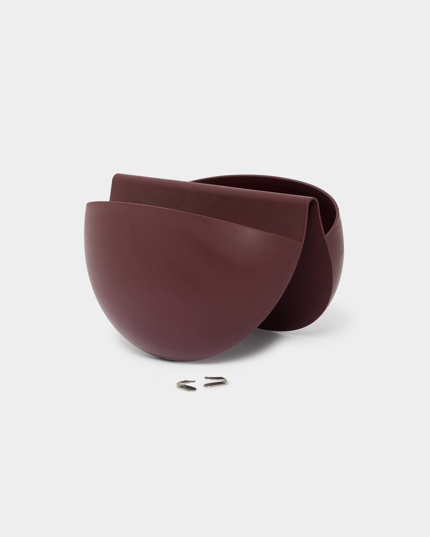 Gro Soft Pocket planter in ox red on plain white background with two metal wall hooks