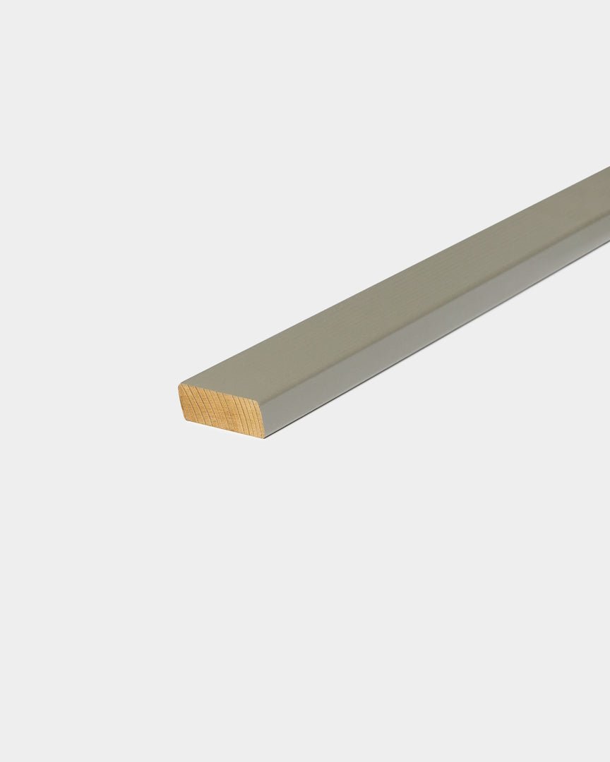 Aluminium cover profile with grey finish and exposed wood end on plain grey background