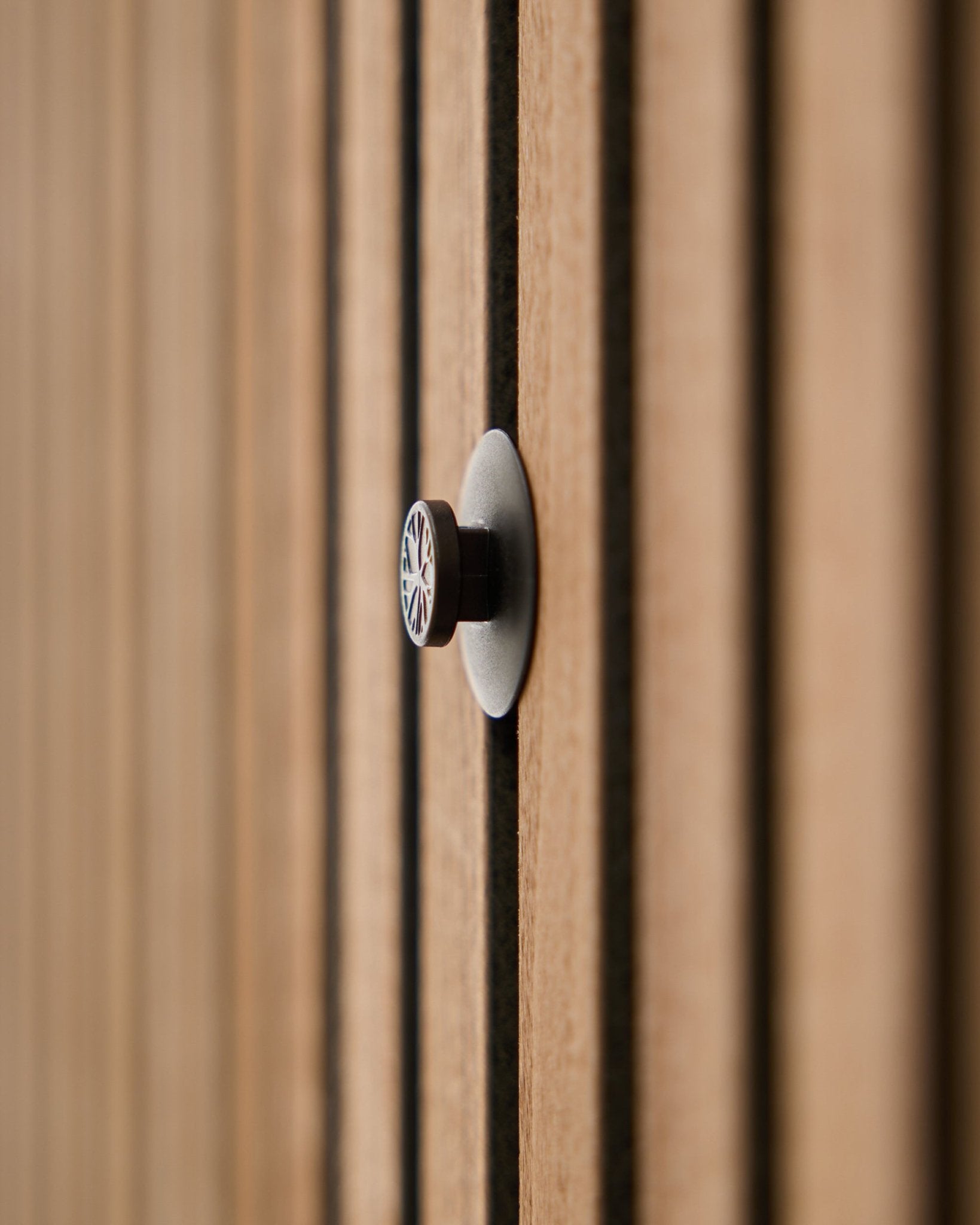 Dupps knob mounted on Akupanel acoustic slat wall panel - close-up