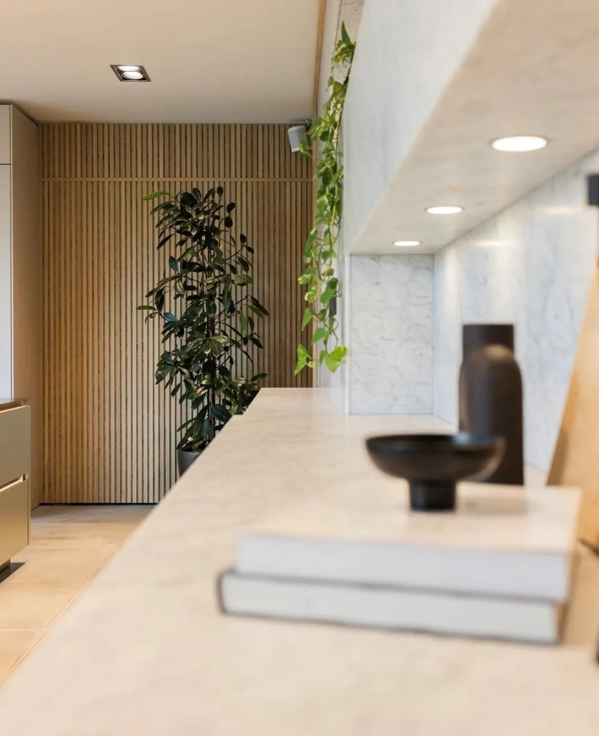Akupanel acoustic slat wall panels in light wood finish on a kitchen interior wall