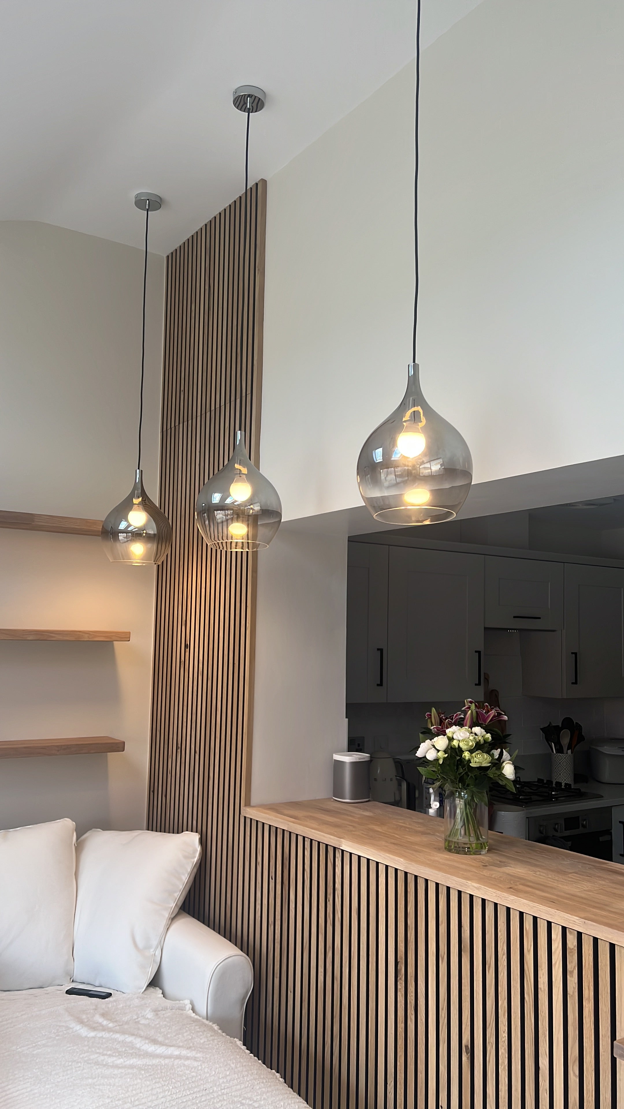 Akupanel oak acoustic slat wall panels on interior wall and kitchen bar front