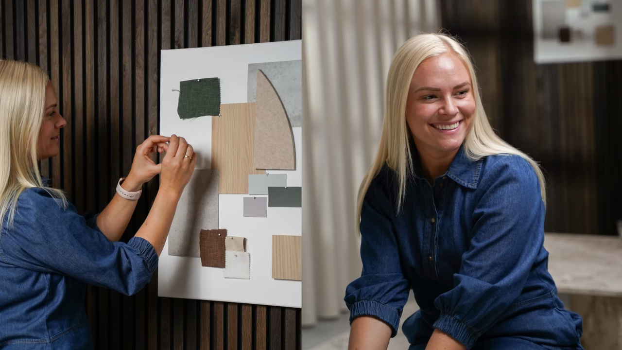 A woman in denim arranges fabric swatches on a board, smiling in a modern workspace with Nordic wood acoustic panels on the wall.